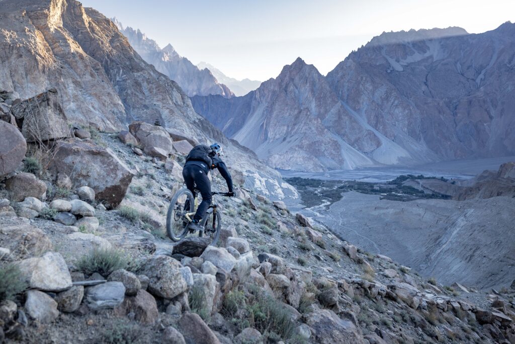 Rider descending technical singletrack near Rakaposhi Base Camp