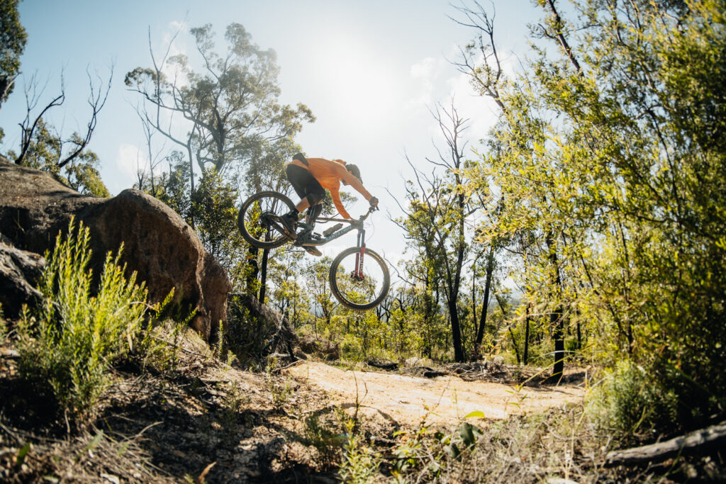 Mountain biker descending on one of the downhill sections at Mogo trail network